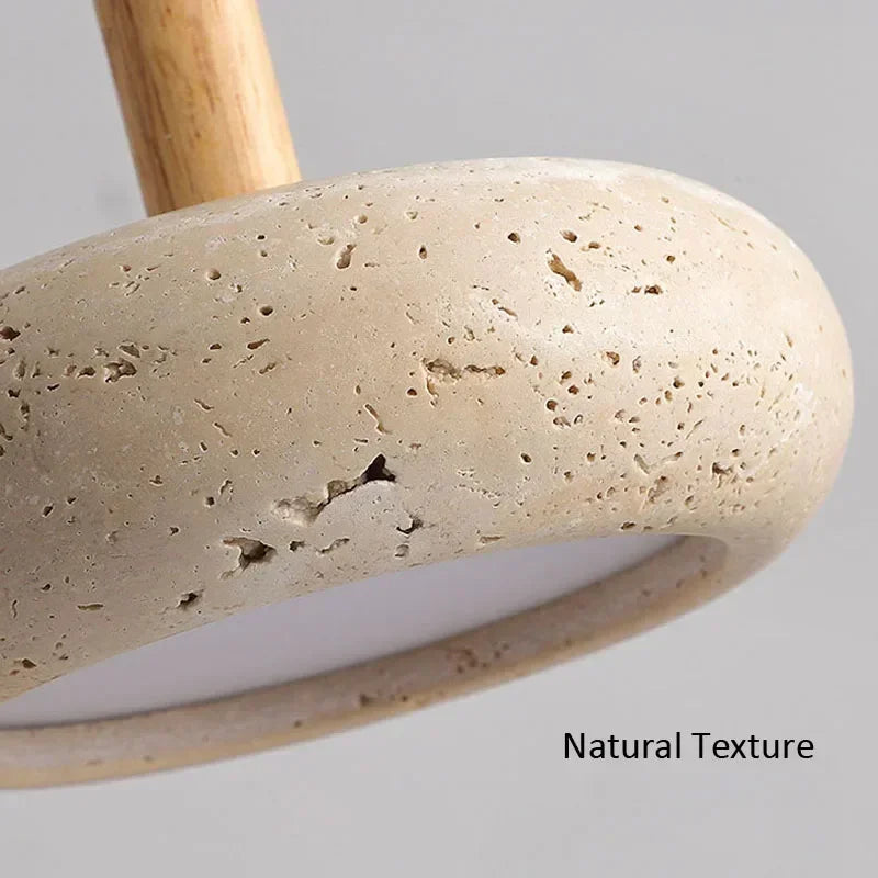 Close-up of the pitted stone surface of a disc pendant light