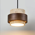 Stone and walnut pendant light seen from slightly below with warm glow