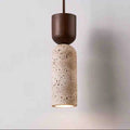 Stone-look bottle-shaped pendant light with a dark wood cap, lit