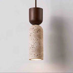 Stone-look bottle-shaped pendant light with a dark wood cap, lit