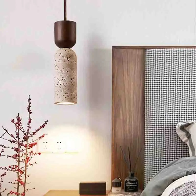 Stone-look pendant light hung beside a wooden headboard