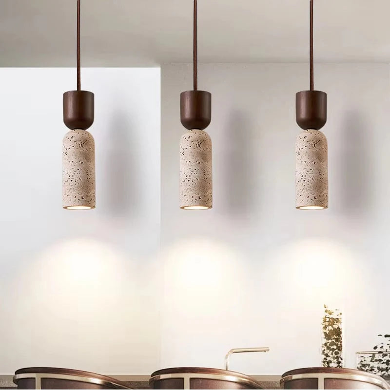 Three stone-look bottle pendants hung in a row over a counter