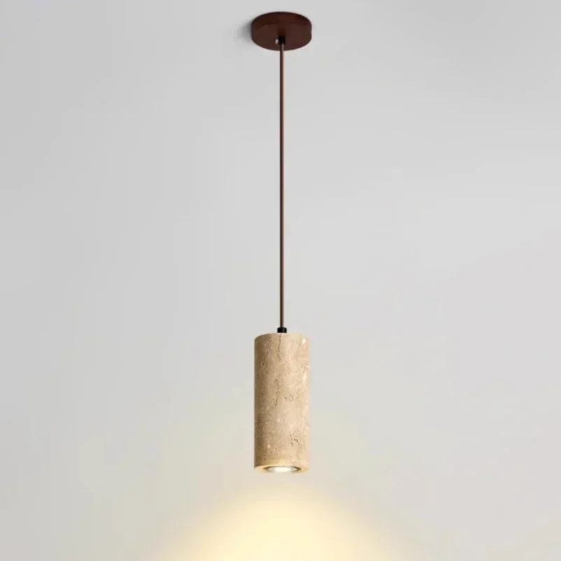 Marble cylinder pendant light with a brown cord and round ceiling plate casting light downward