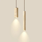 Two marble cylinder pendant lights of different widths glowing against a cream wall