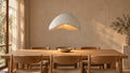 White Wave pendant light over an oak dining table