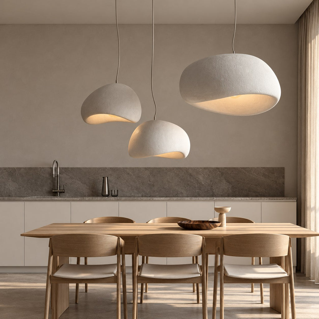Three white pendant lights over a dining table (sold individually)